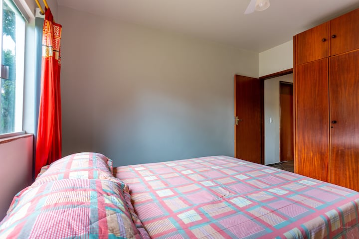 Bedroom on the ground floor, with a double bed. The view lies ahead of the farmhouse.