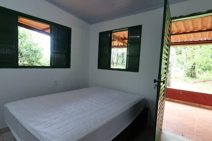 Suite outside the house, with a double bed. This suite is next to the barbecue. This suite has a private balcony there.