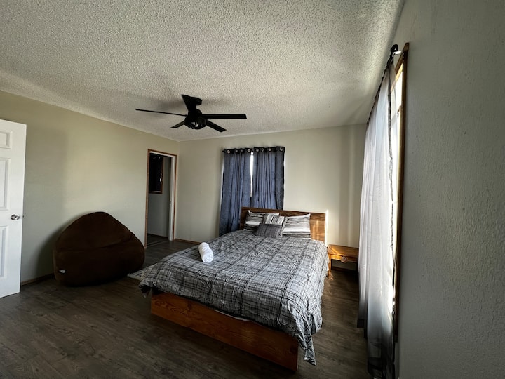 Bedroom 1: View from the closet area. Large master bedroom with queen size bed and en suite bathroom with standing shower.