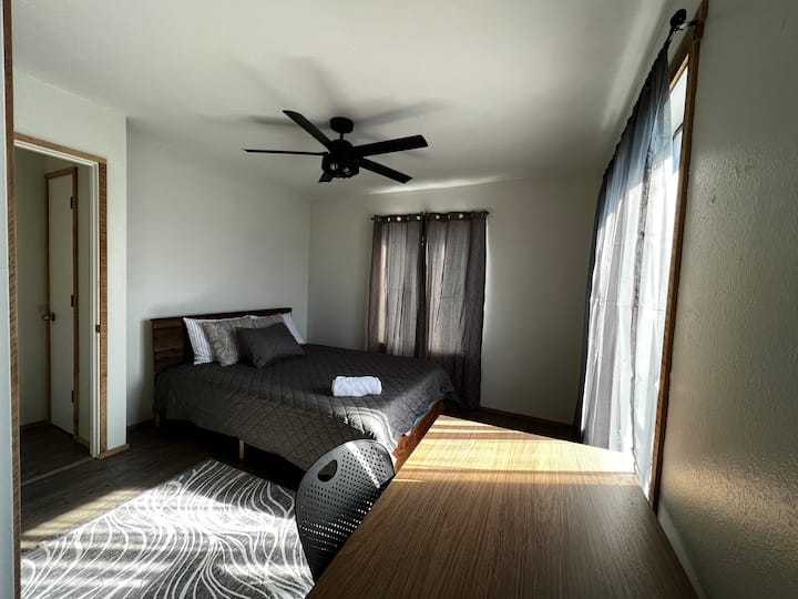 Bedroom 2: View from the open closet area. South-facing window allows for lots of sun during the day. Ceiling fan helps keep the room cool. Floor heater keeps the room comfortably warm.