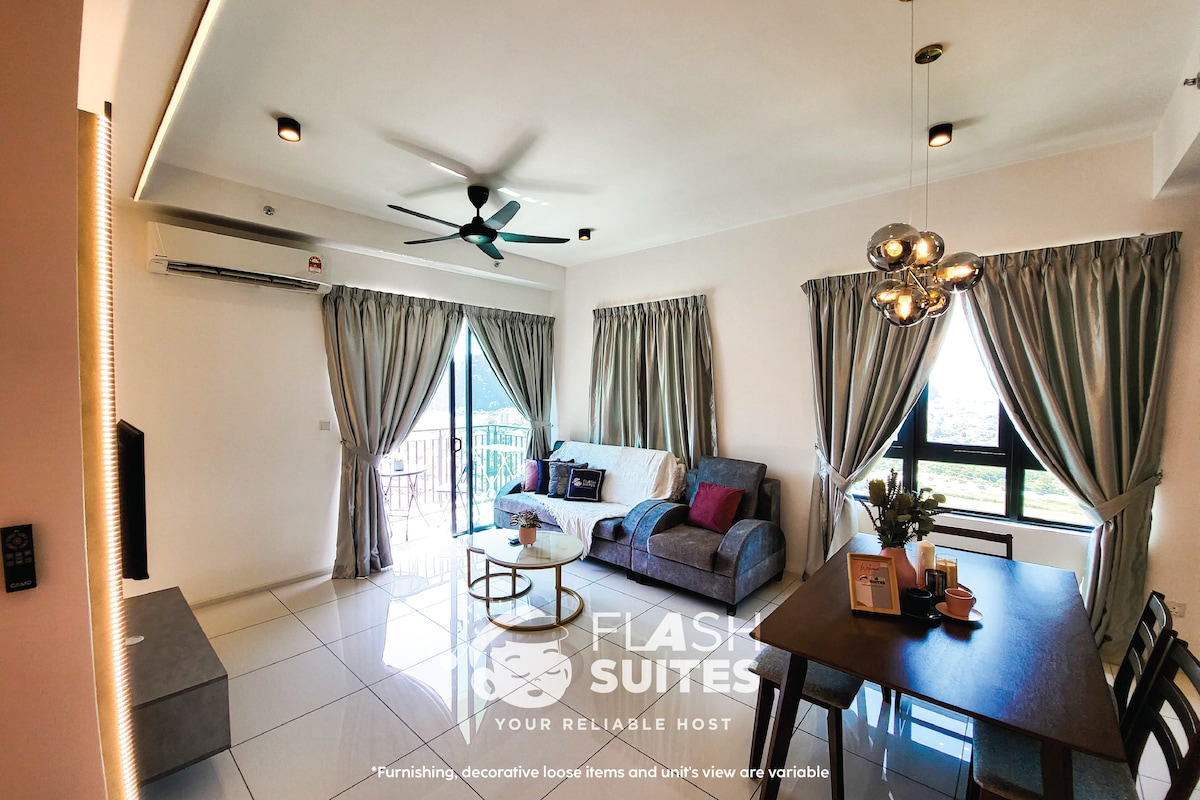 A bright living area features large windows with flowing curtains, allowing natural light to illuminate the space. A comfortable sofa and armchair are positioned around a coffee table, while a dining table with chairs completes the space. Air conditioning is also provided for comfort.
