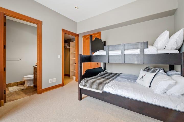 Bedroom 5. Located on the ground floor, it has a bunk bed with a bottom double  bed and a top twin bed with an ensuite bathroom with a shower. It is next to bedroom