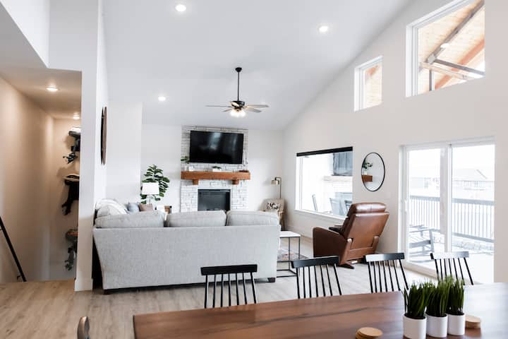 Living area with Smart TV, sectional couch, and Lazy Boy power recliner. 
