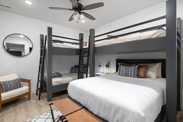 Custom bunk room with queen bed and 3 twin XL beds.