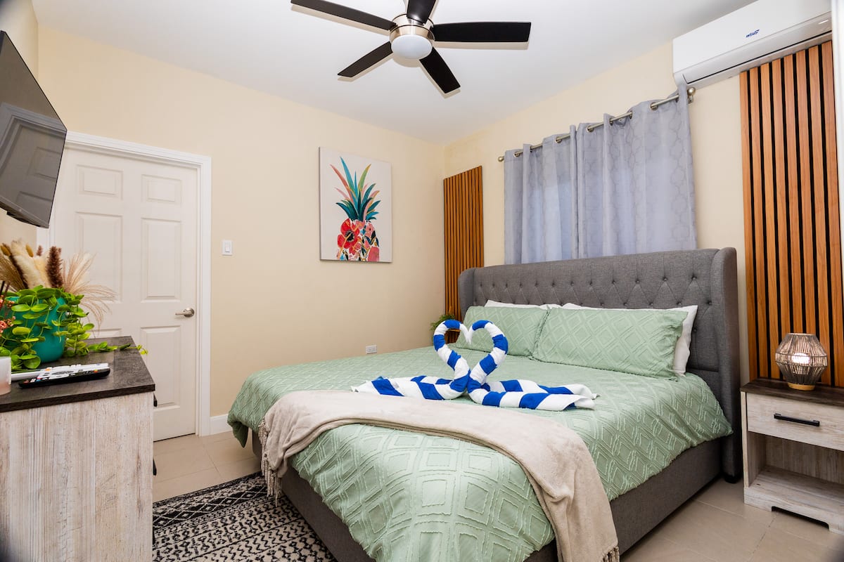 Primary bedroom with king bed at Ocean Escape Jamaica villa, the kind of private room a group needs to actually divide guests comfortably