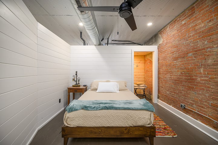 Bedroom with queen bed and spacious closet.