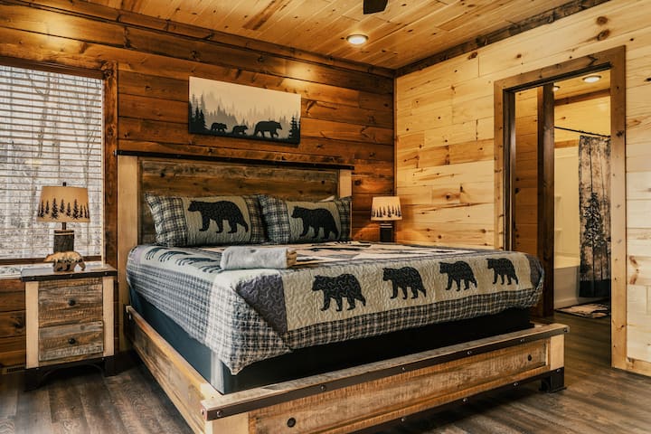 Downstairs king bedroom with en suite bathroom, smart TV, and private deck. 