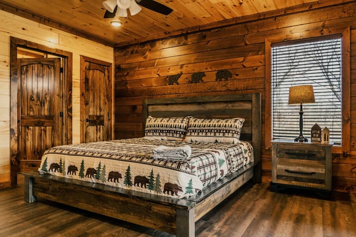 Downstairs king bedroom with en suite bathroom, smart TV, and deck access to swim spa. 