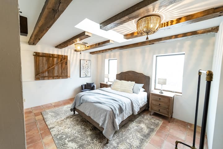 “The Loft”. Queen Bed. Bookshelves, sink with a mirror, barn door style window overlooking great room (locked for guest’s safety)
