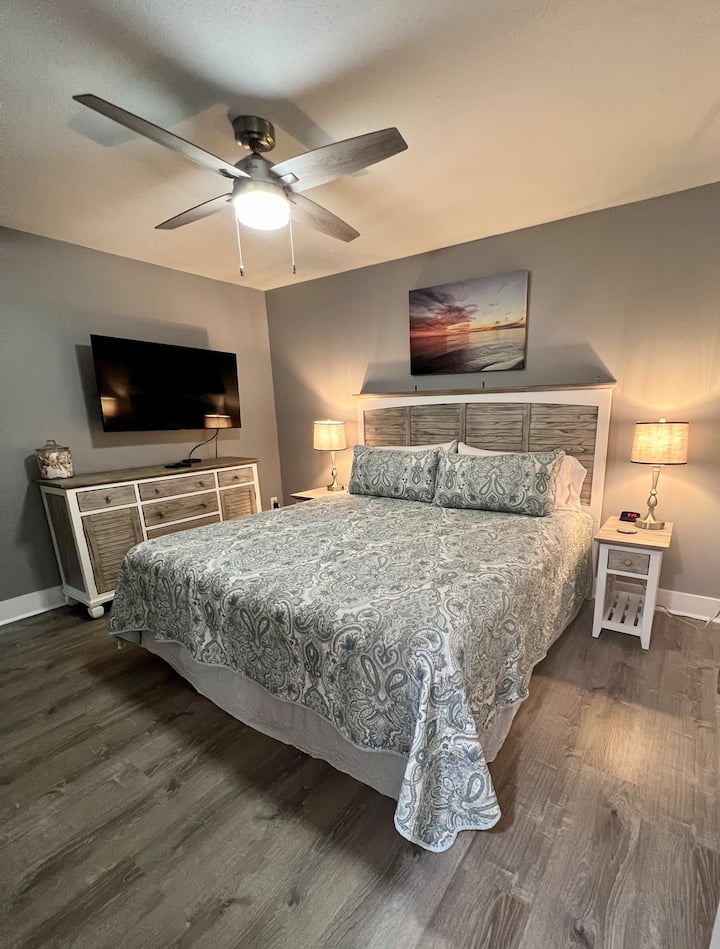 Master Suite has king mattress, smart 50" TV and a balcony with 2 chairs & a table. Clothes hangers, box fan, luggage rack, ironing board & iron. Extra blankets & pillows. Dresser, two nightstands, lamps with usb chargers, alarm clock. 