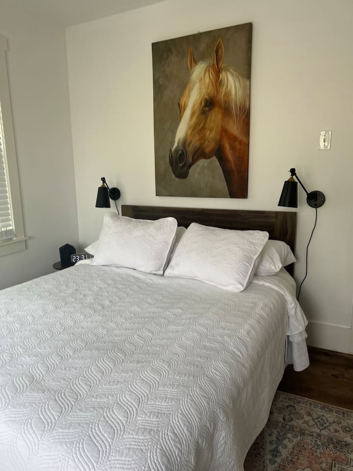 Our "master" bedroom is a quaint space that holds a queen bed and views of the Guadalupe River.  All linens and towels are 100% upgraded, cotton. NOTE: EVERYTHING is completely replaced and sanitized between stays. 