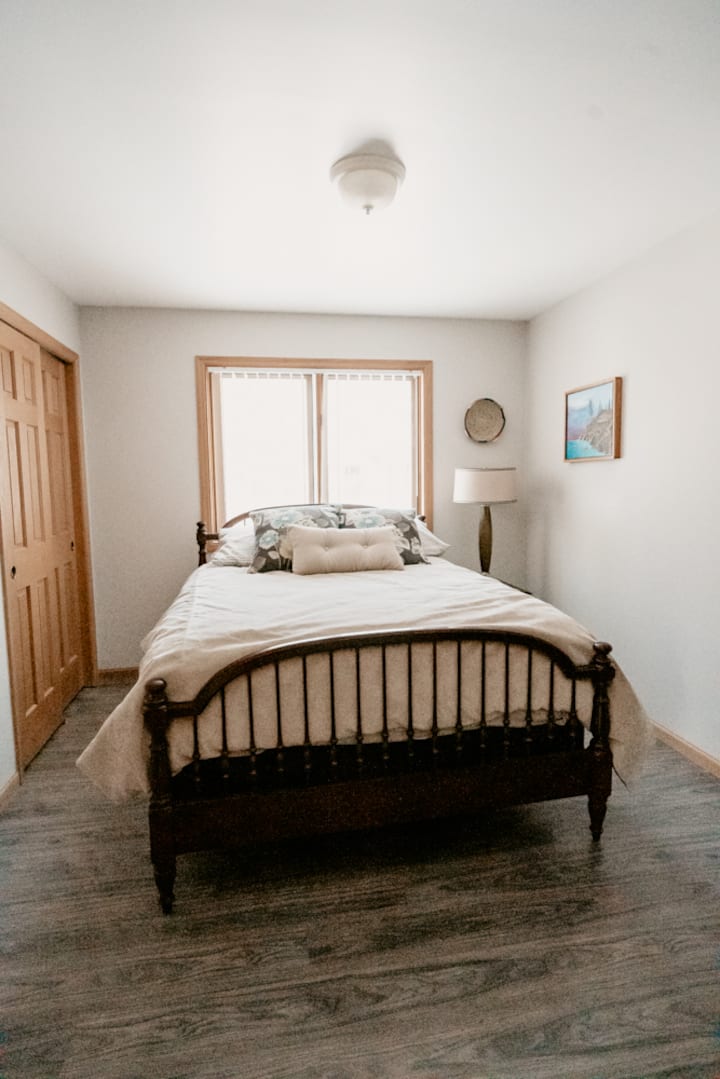 Main level bedroom with comfy bed, large closet, and dresser.