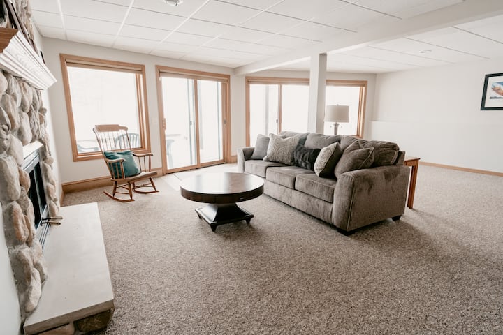 Lower level finished basement living area. The patio doors go out to the lower balcony where you can watch the northern lights or walk out to the private beach on the marked path.