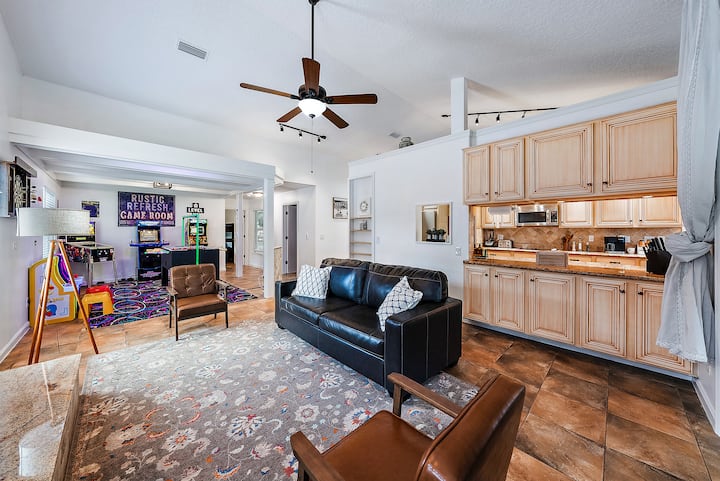 Living area #2 has a queen sleeper sofa, counter and cabinets, fireplace (not pictured). Further ahead is the arcade room area.