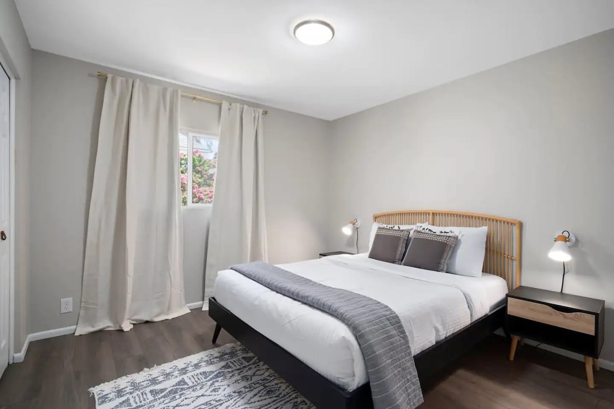 Guest Bedroom #3: A stylish bedroom with a queen-sized Leesa mattress and blackout curtains.