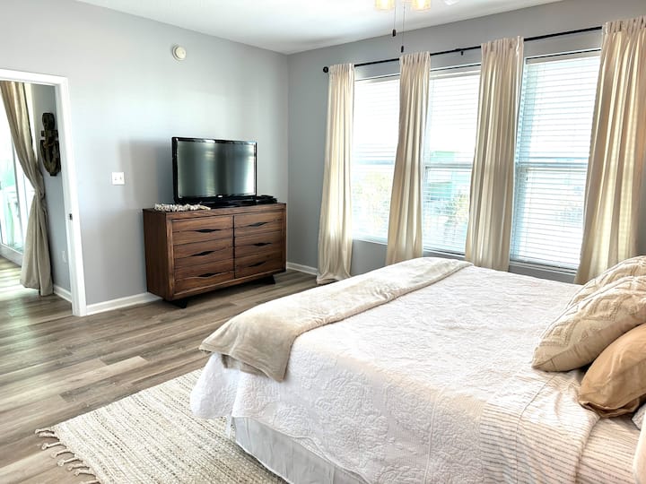 Mater bedroom with view of marina and satellite TV. 