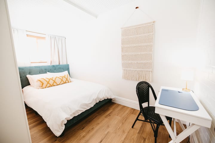Second bedroom, better known as the Sunroom, is a cozy well lit space with a quiet work nook and closet located off of the kitchen.