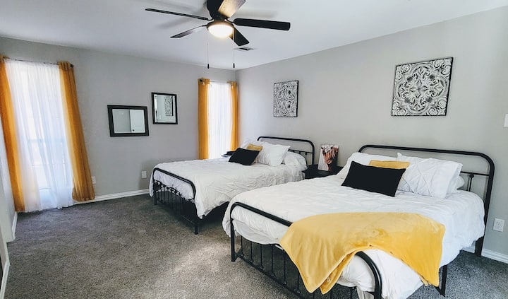 The spacious second bedroom equipped with two queen beds. This room features an adjoining bathroom and a door that opens to the sunroom.