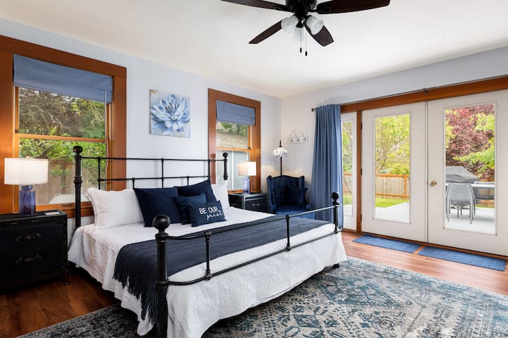 [Bedroom 1] First floor master with King Bed and French Doors opening to outdoor deck.