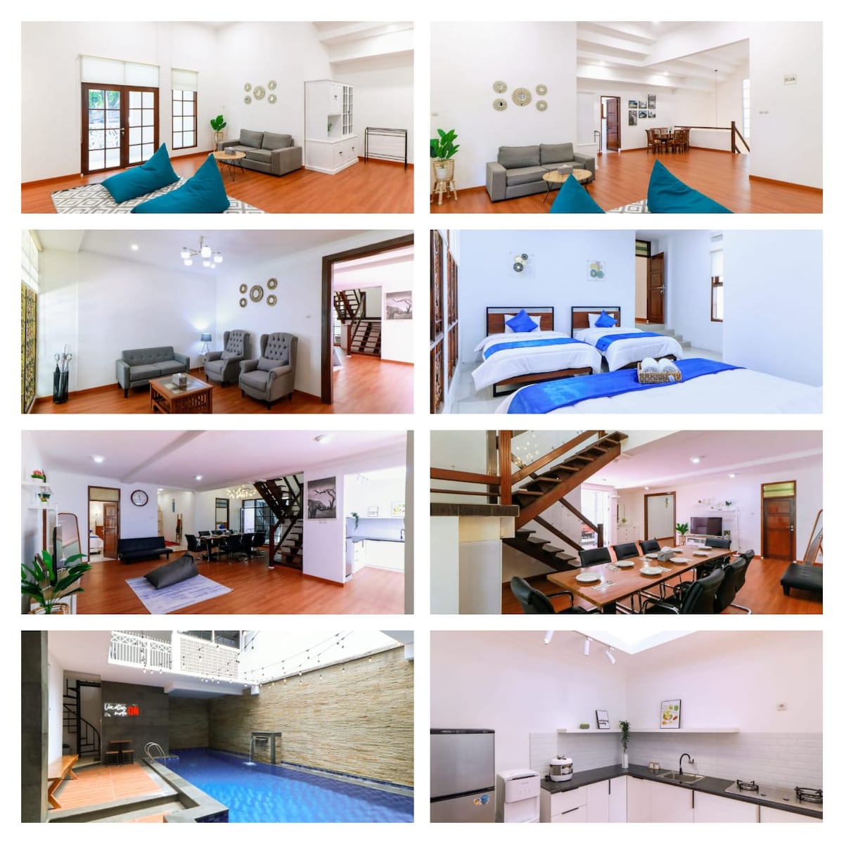 An open living area features modern seating arrangements with decorative cushions. Natural light filters through large windows, illuminating the warm wooden floor. Minimalistic wall decor adds a touch of elegance to the spacious layout, enhancing the inviting environment for gatherings.