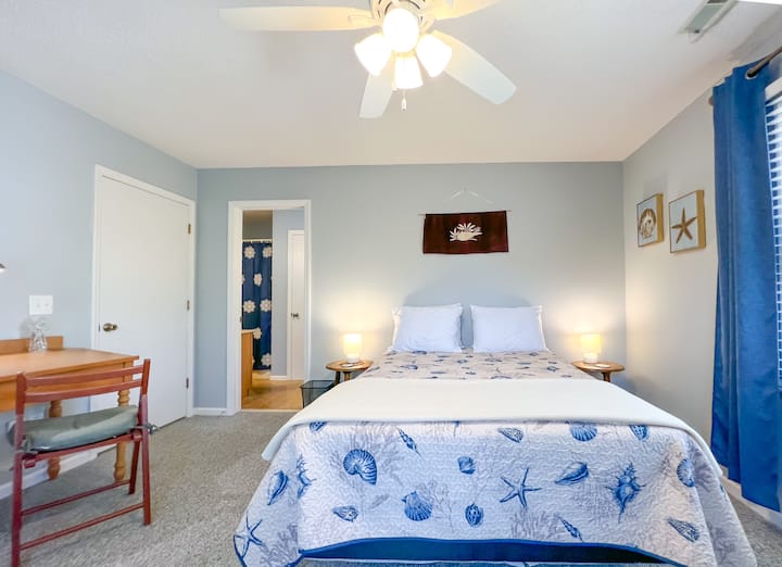 Queen bed with extra pillows and room darkening drapes ensure everyone can sleep in.