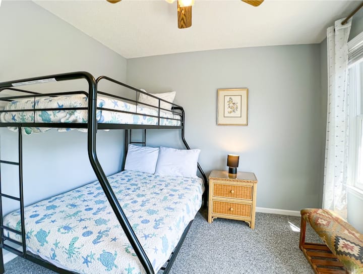 This room boasts a twin over full bunk, small dresser and ceiling fan. Perfect for the kids!