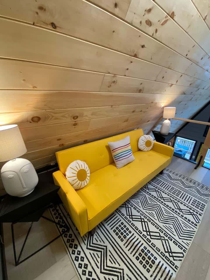 Sunny yellow futon in the loft. It folds down to a twin bed.