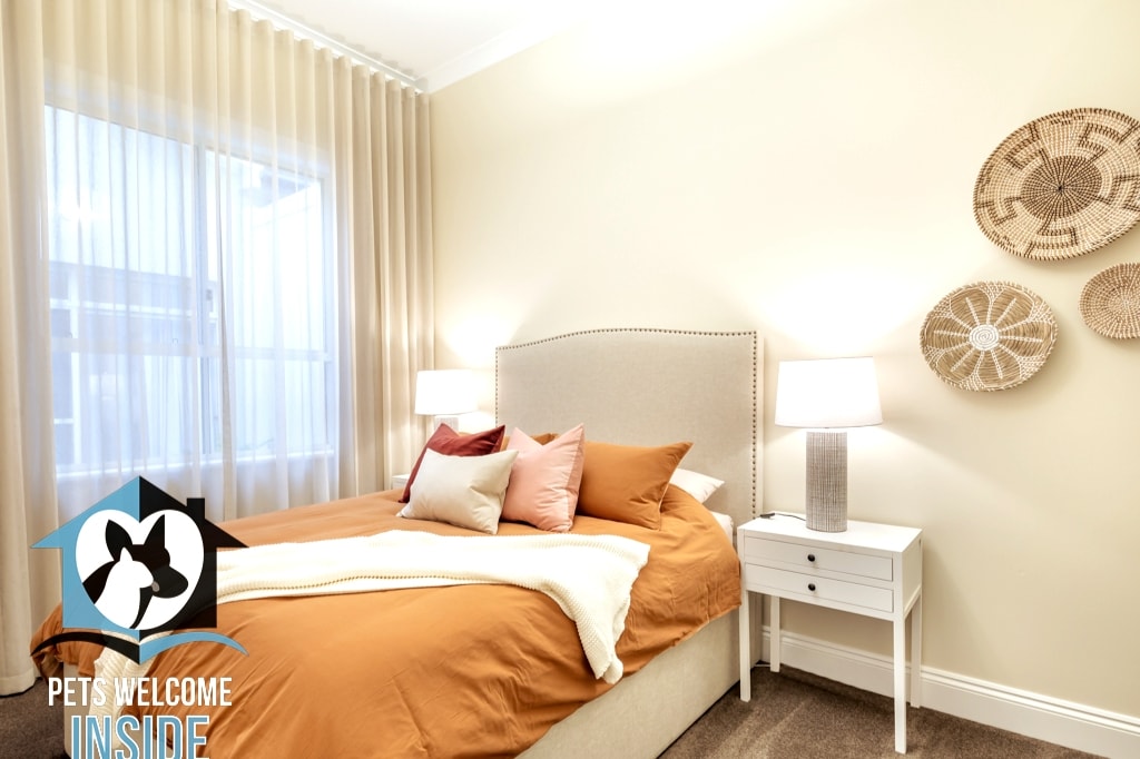 Each  bedroom has a distinct colour theme –this one is a burnt ochre with beds freshly made for guest arrival with sheets, pillowcases and quilt covers.