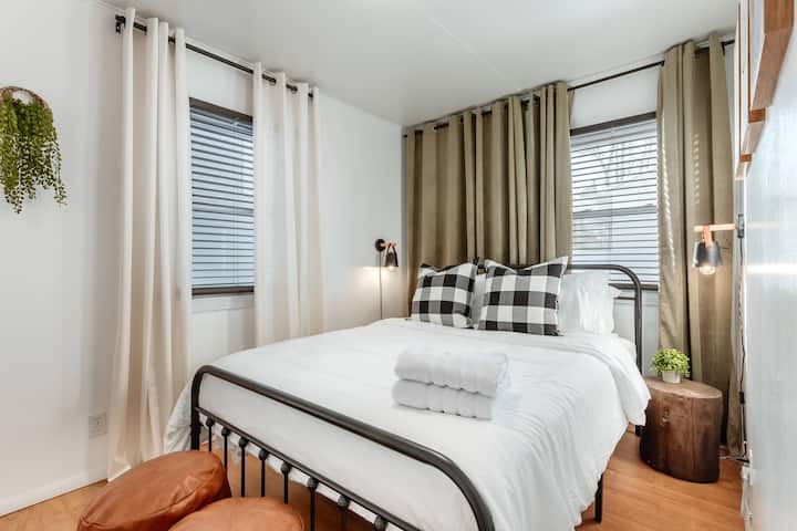 The secondary bedroom features a queen bed, velvet blackout curtains, and hotel quality linens as well.