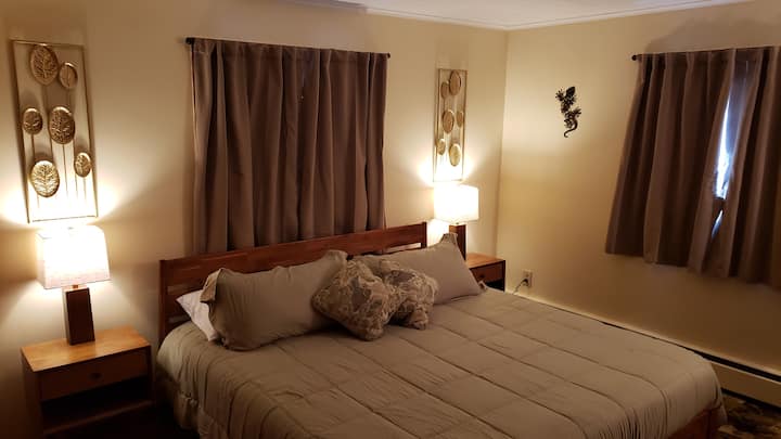 The master bedroom sports a giant King bed with a brand new memory-foam mattress. These curtains are 'black-out' so set the alarms for morning cause you won't see it coming. 