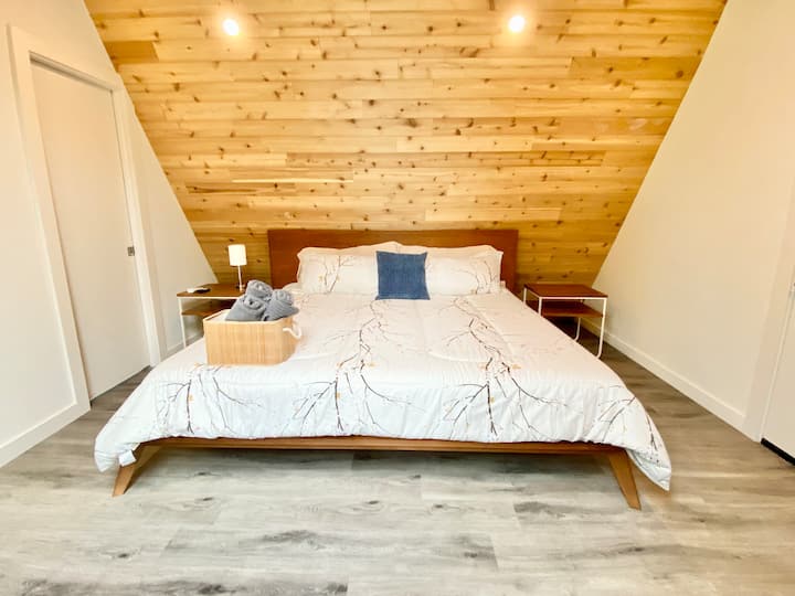 Upstairs masters bedroom boasts King bed & ensuite bathroom with shower. Access to outdoor patio that sits over the a-frame's carport. 