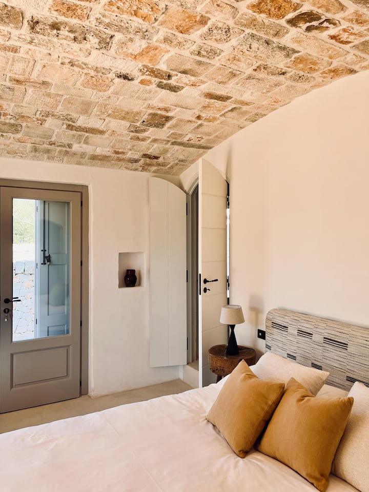 Entering the barrel roofed double bedroom, you will find a gorgeous space with private terrace replete with stunning views of the garden.