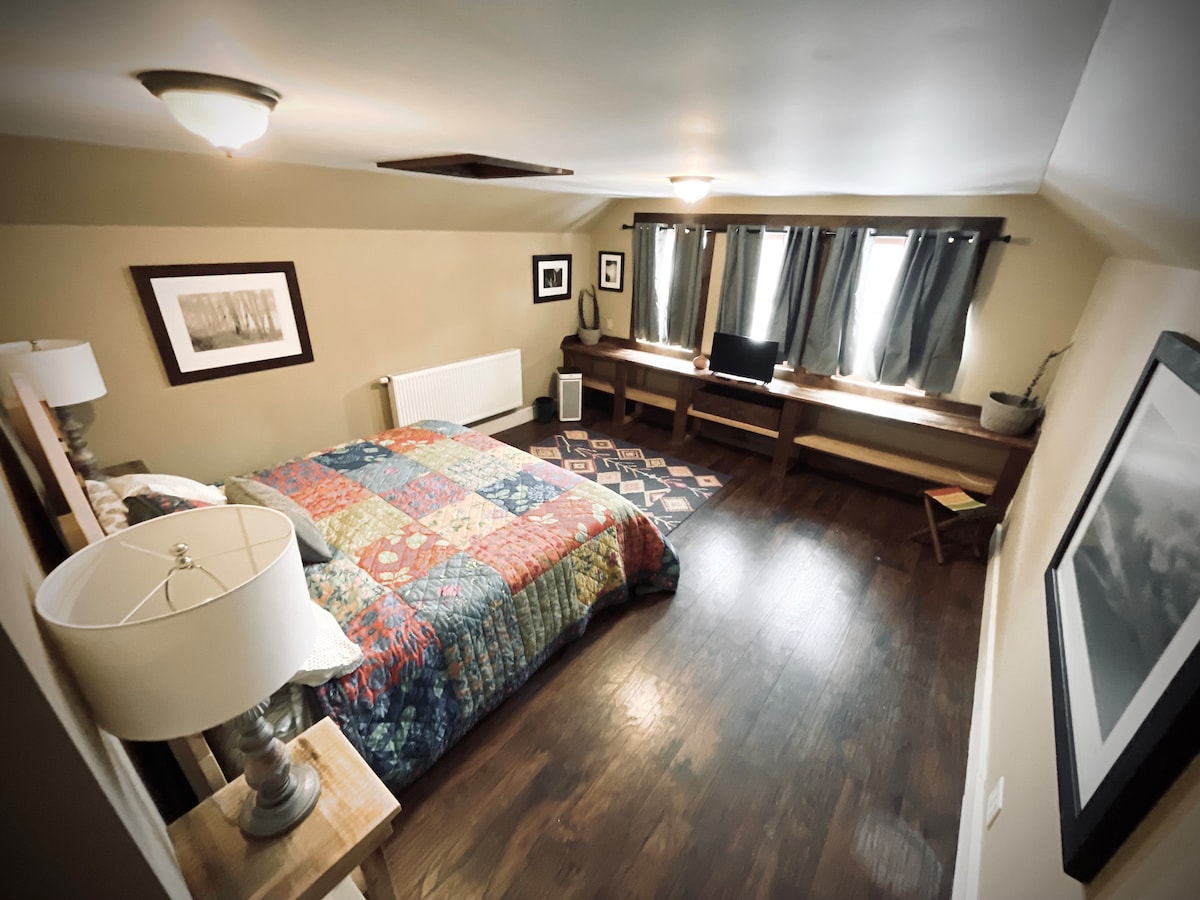 Spacious upstairs bedroom with a handcrafted king size bed