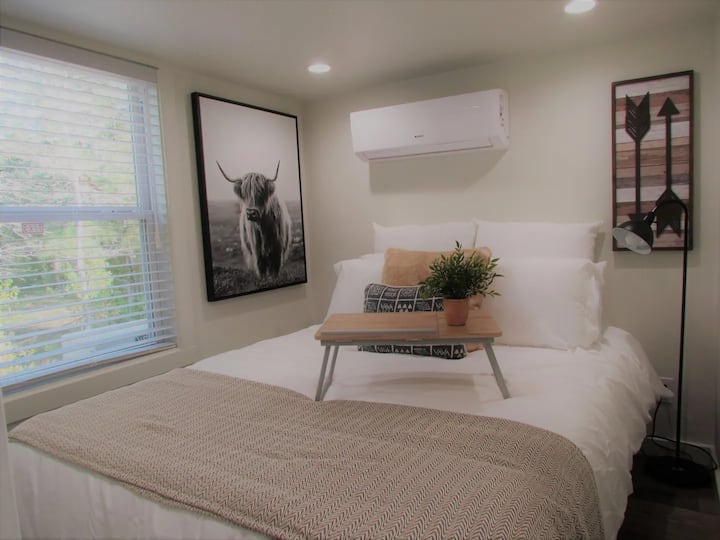 Sink into the plush queen size bed in the downstairs bedroom and enjoy a tree lined view from your window.  We've even provided a reading lamp for the book worm and your own air conditioner for the perfect sleeping temp.