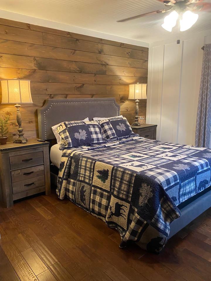 Wood accent walls provides a rustic backdrop for the master bedroom