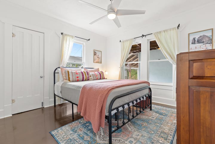 Sleep comfortably on the queen bed in a bright and modern bedroom. The closet is locked for housekeeping, but clothing can be stored in the dresser.