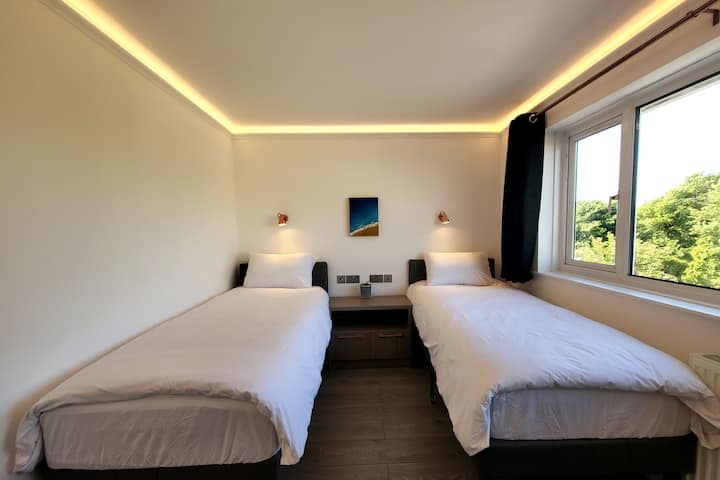 The upstairs twin bedroom has two single- sized beds with 100% cotton bedsheets and comfortable pillows to relax after a day out at Portland Bill, Chesil beach or a drive to Durdle Door. 
It also has black out curtains so you can sleep well.