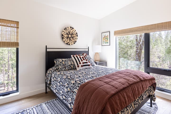Guest bedroom with forest views.