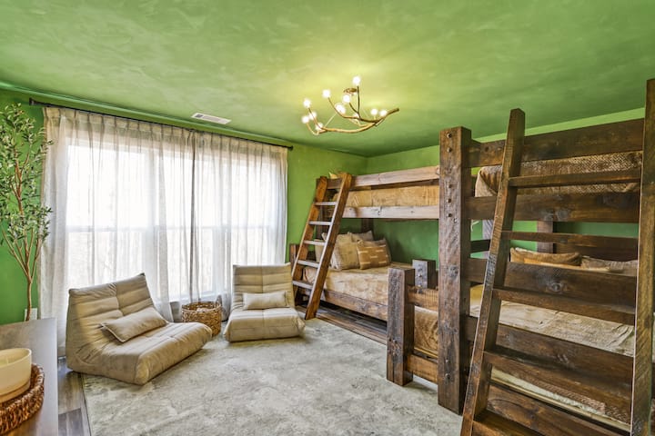 Featuring two queen beds and two single beds, this room offers rustic wooden bunks, large windows, and comfy seating.