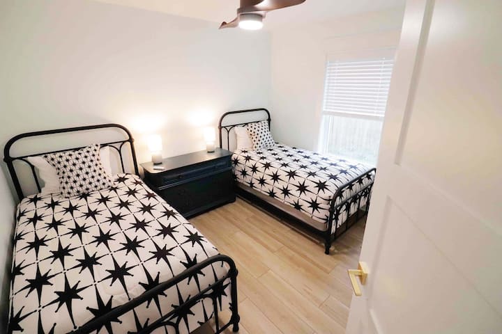 Two twin beds are in this first floor bedroom perfect for kids to share, an inflatable mattress is also available in the closet. The spacious dresser provides lots of storage for clothes, and each bed has it's own bedside lamp.