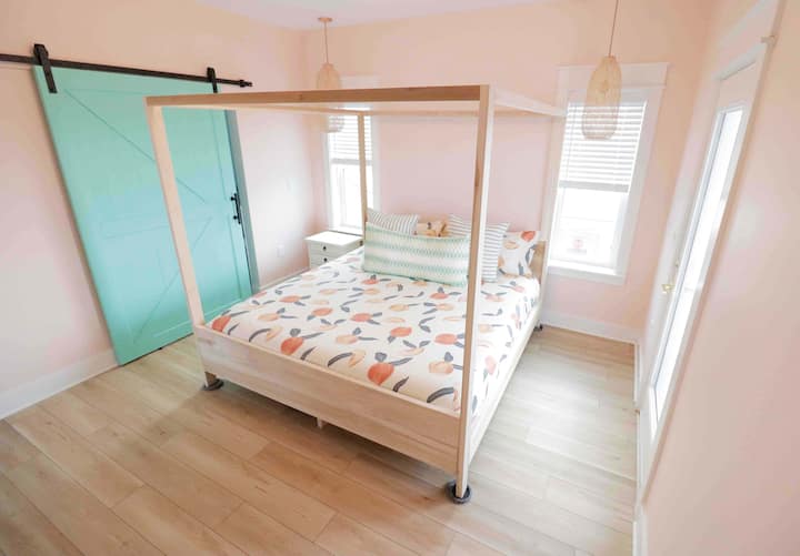 The 3rd floor master bedroom contains a king size canopy bed with a brand-new, comfortable Nectar mattress. This spacious master bedroom is on the third floor with direct access to the ocean view balcony. Black-out curtains provide a peaceful rest. 