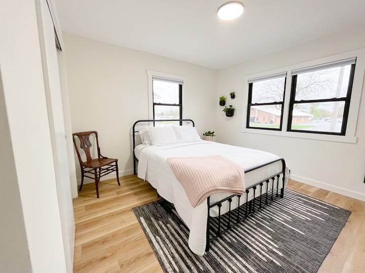 Bedroom 2 features a queen size bed, blackout shades, and closet complete with additional storage cubbies.