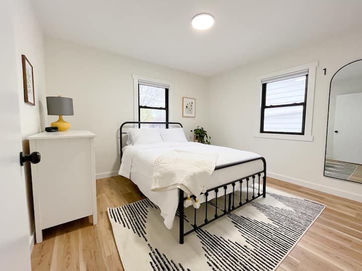 Bedroom 1 features a queen size bed, blackout shades, dresser, and closet.