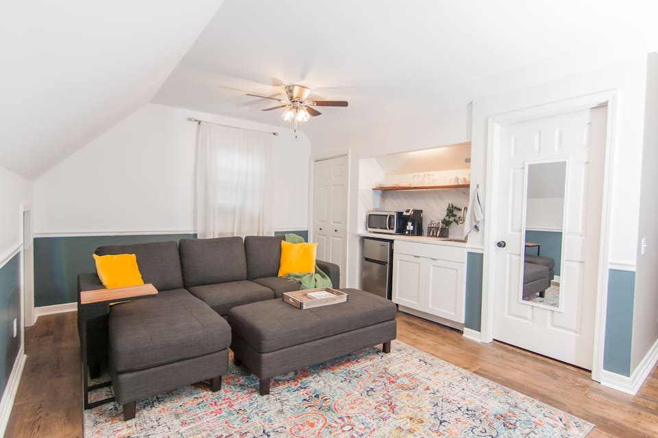 Sofa and TV area with the kitchenette behind