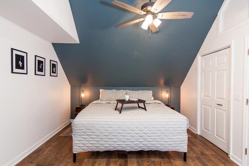 Bedroom with the blue accent wall and ceiling fan