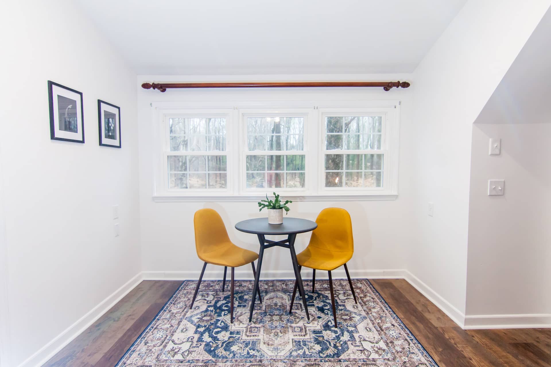 Dining nook with two yellow chairs by the window