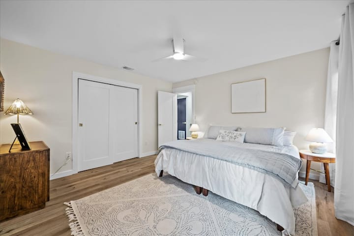 Primary Bedroom: Bright and airy retreat with a king bed, stylish decor, and serene ambiance.