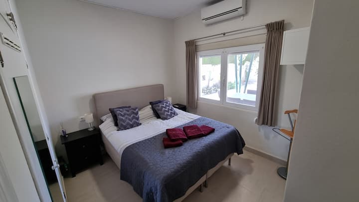 bedroom with queen bed and A/C