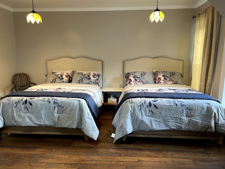 Room #3: Hestia
Large Double Bedroom featuring two modern framed queen sized beds
Spacious wooden dining table with vintage chairs; Original 19th Century closet