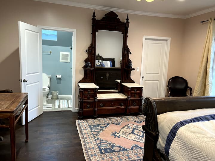 Room #2: Persephone 
Large Single Bedroom featuring a one of a kind antique bed frame,  with a king size mattress; Styled with antique vanity and table; Fully renovated bathroom with walk in shower and large walk in closet